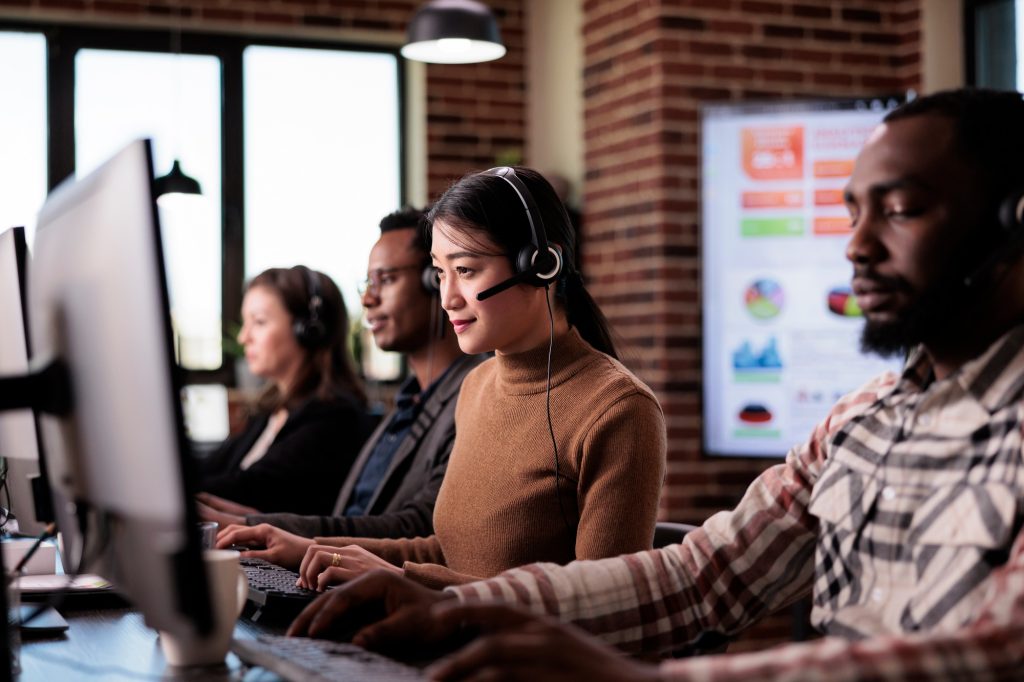 Asian woman working as sales consultant at call center service